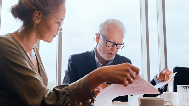 A senior client meeting with a financial advisor to optimize his nest egg for taxes.